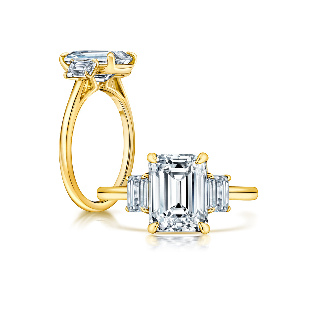 Three stone Emerald cut ring with peekaboo shank