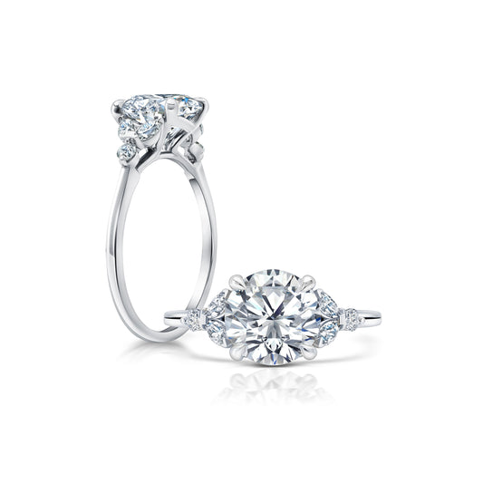 Uniquely set Marquises and Round Diamonds on each side of the center Diamond